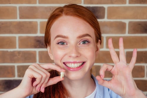 Woman with tooth in her hand