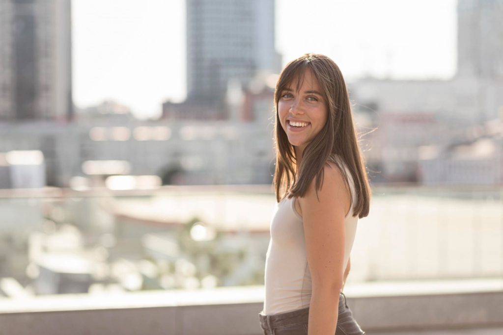 In the heart of New York City, a resilient individual post-tooth extraction. The person displays a sense of strength and determination, navigating the urban landscape with care. Despite the recent dental procedure, their spirit shines through against the iconic backdrop of the city that never sleeps.